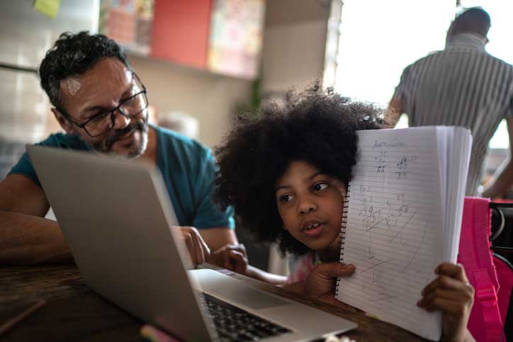 parent helping kid student with online learning