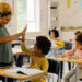 A teacher having a high five with her student in the classroom